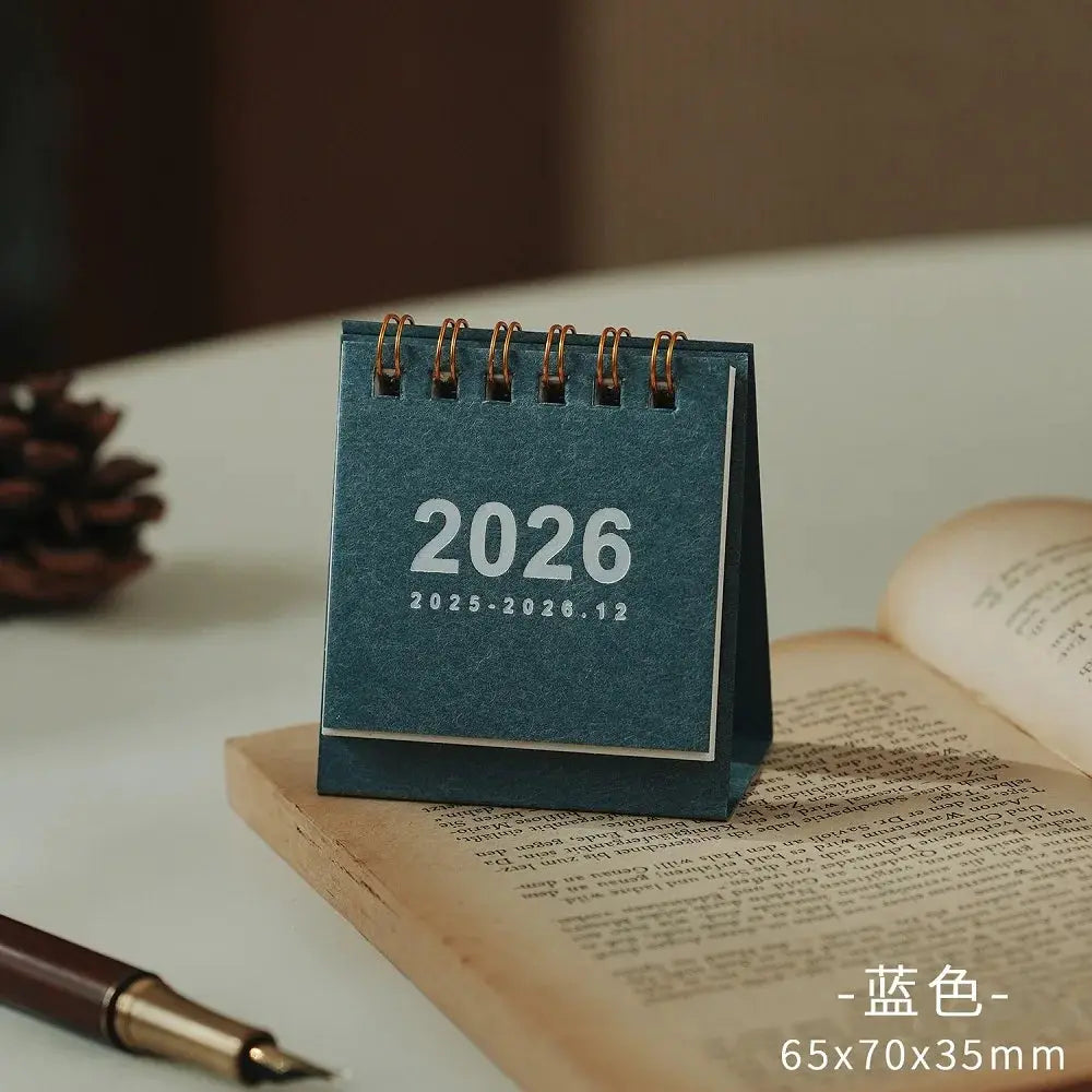 Mini blue desk calendar 2026 with copper coil binding, Simples Market office stationery 65x70x35mm