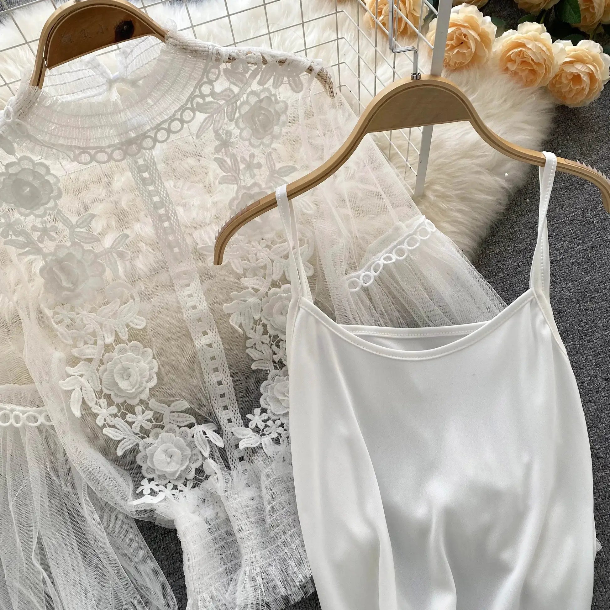 Lace puff long sleeve blouse, white sheer floral lace fabric on a wooden hanger