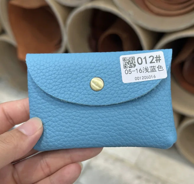 Blue genuine leather card holder with textured cowhide, envelope-style flap and brass snap.