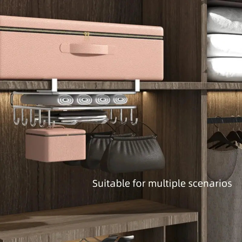 Stainless steel hanging kitchen rack with hooks and pink paper towel/utensil holder under a wood shelf