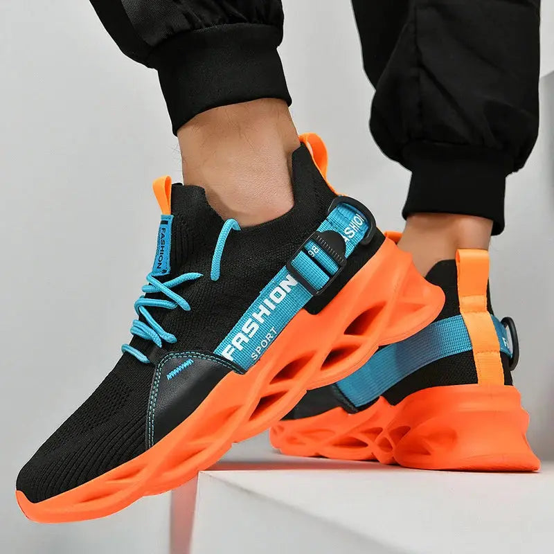 Sneakers with black mesh upper, bright orange thick sole and blue laces.