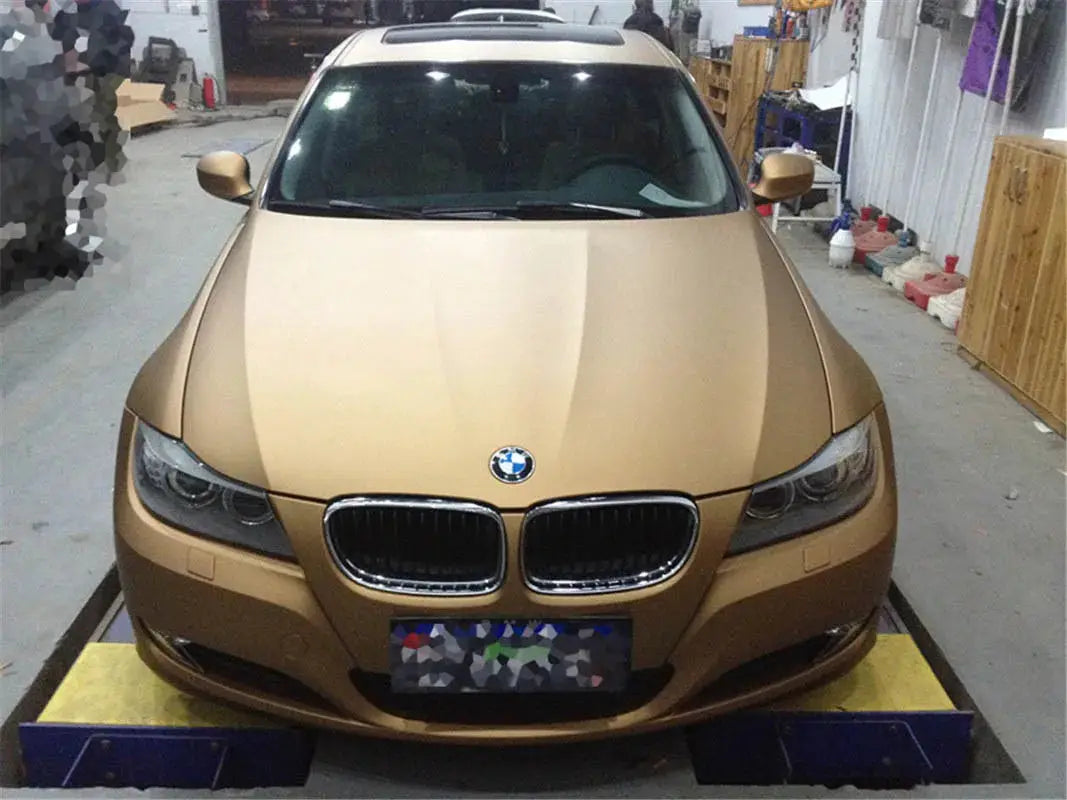 Matte gold car wrap vinyl film by Simples Market with air release channels on a BMW sedan