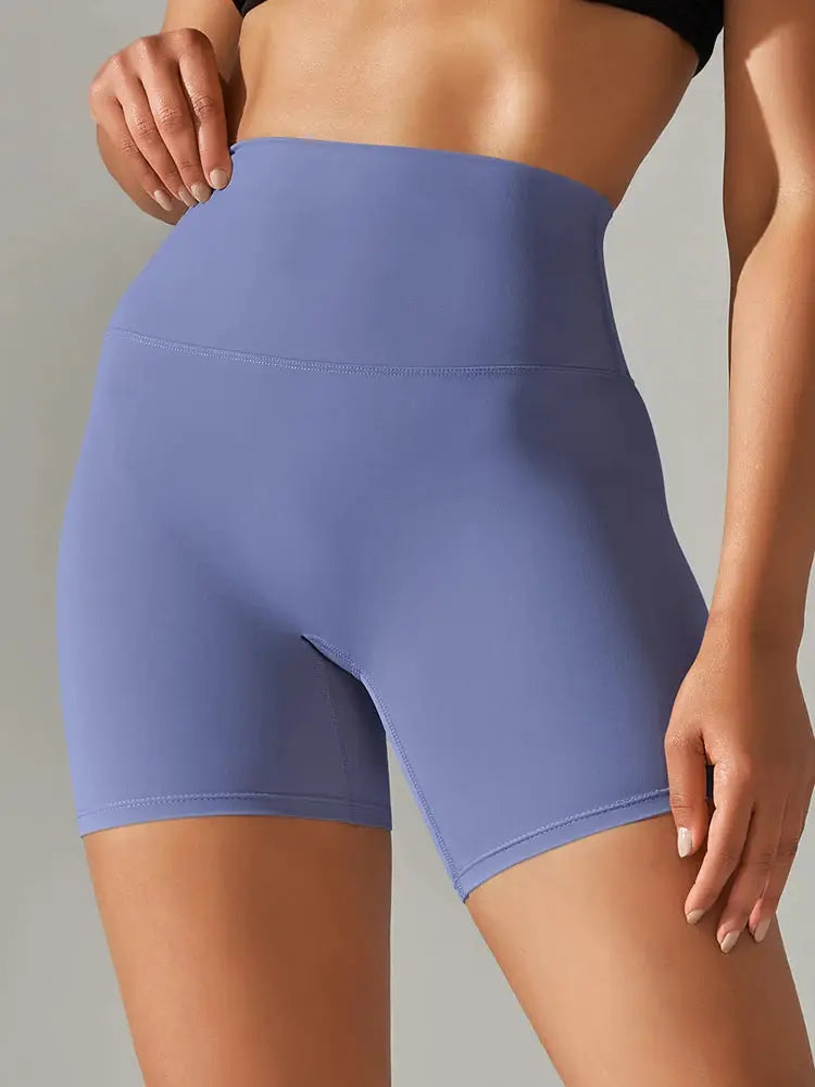 Women's purple high-waist yoga shorts with stretchy fabric for workouts