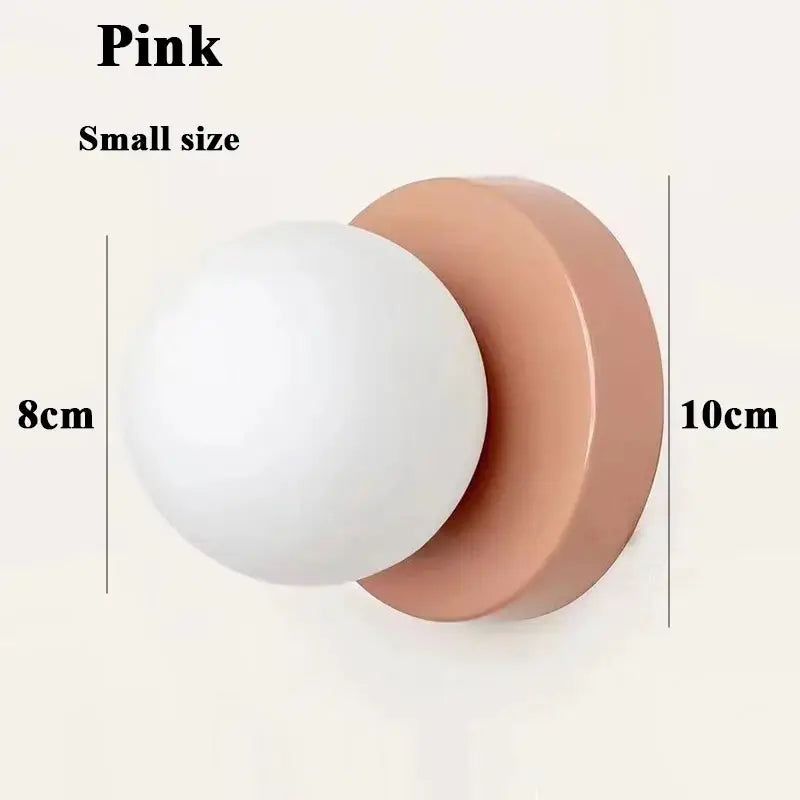 Pink macaron-style small wall lamp with white plastic ball lampshade and iron base