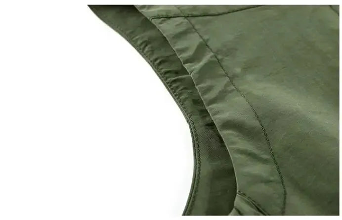 Men's olive-green outdoor cargo vest close-up of armhole stitching