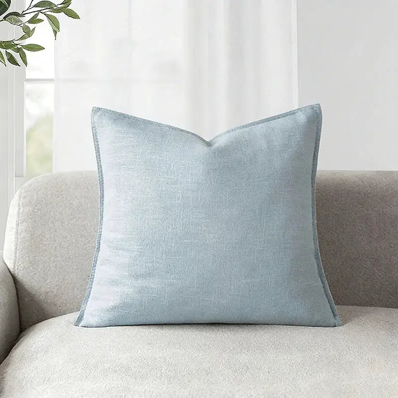Decorative ramie cushion cover in light blue on beige sofa