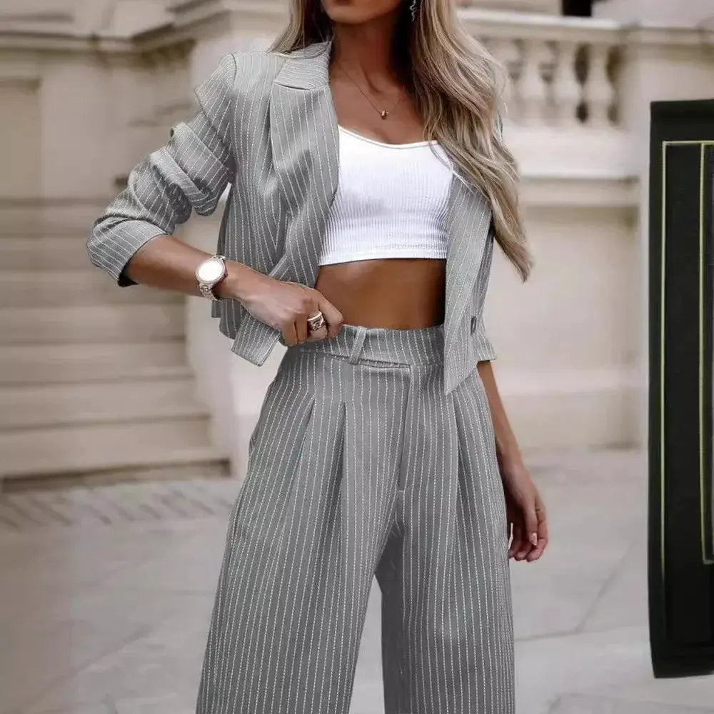Women's gray pinstripe two-piece pantsuit with short-lapel blazer and straight pants