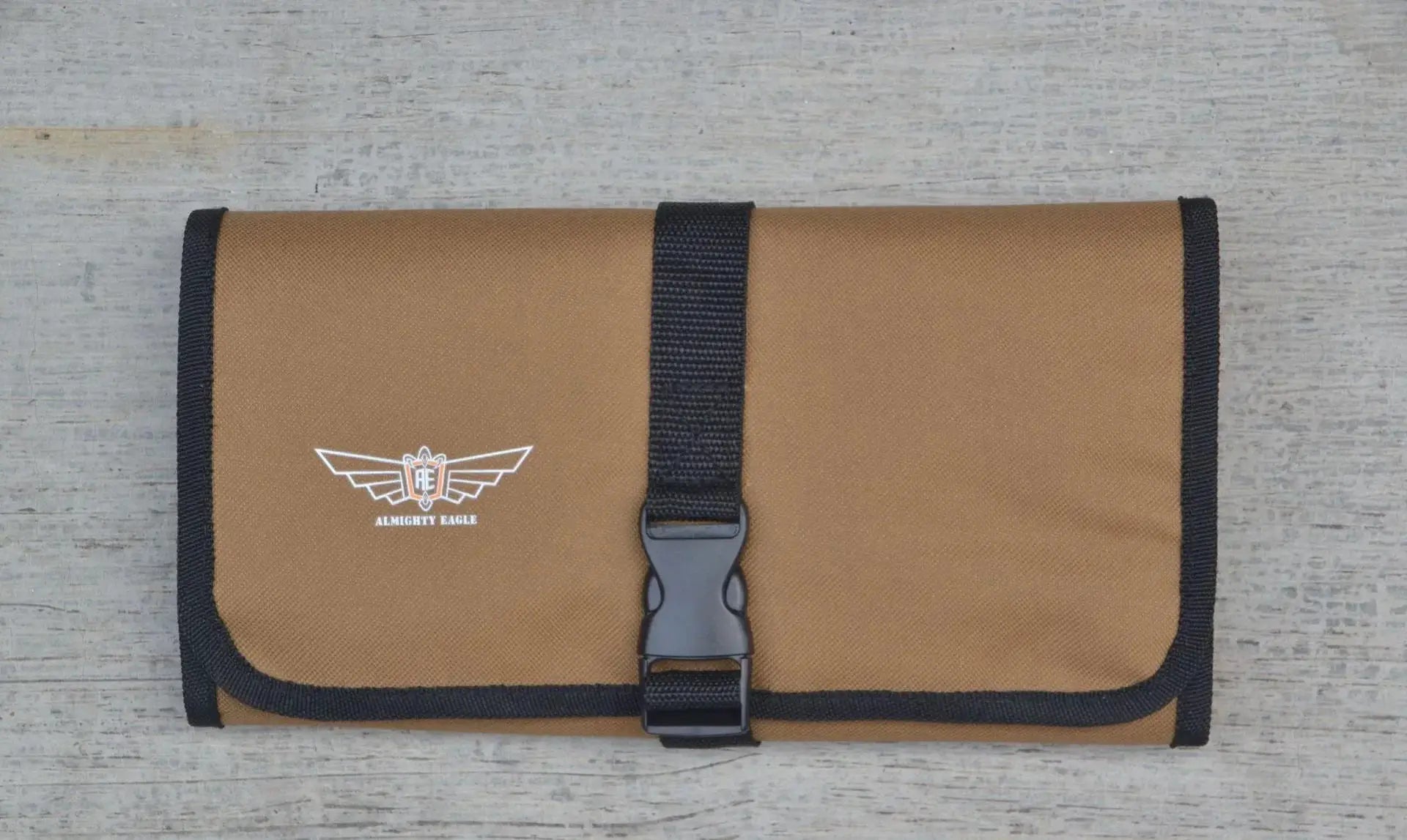 Tool roll pouch in brown Oxford cloth with black trim and buckle, Almighty Eagle logo.