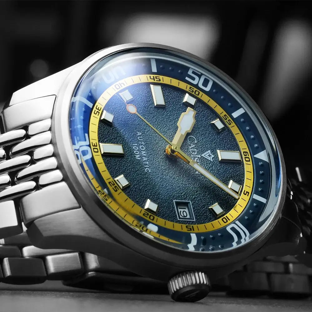CADISEN automatic men's watch with blue textured dial, gold-tone ring, steel bracelet, domed glass MIYOTA 8215 movement