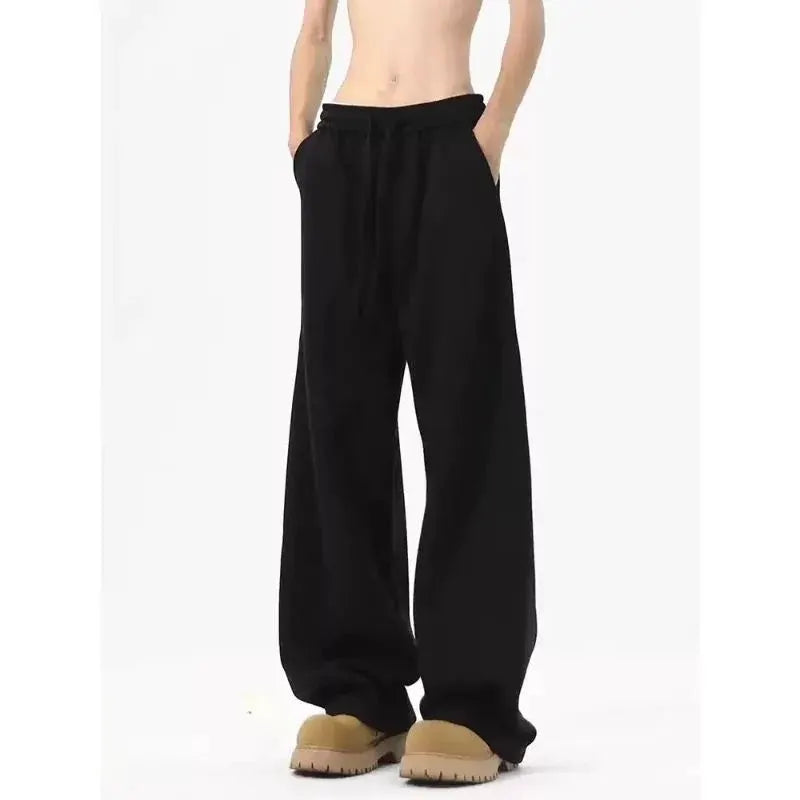 Men's black straight-leg sweatpants with drawstring waist and oversized pockets; loose-fit joggers.