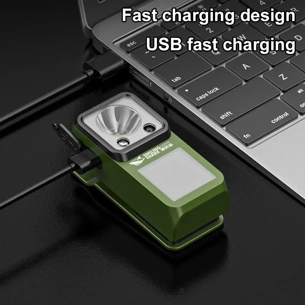 LED magnetic clamp flashlight, green USB rechargeable camping light by Simples Market, plugged into laptop.