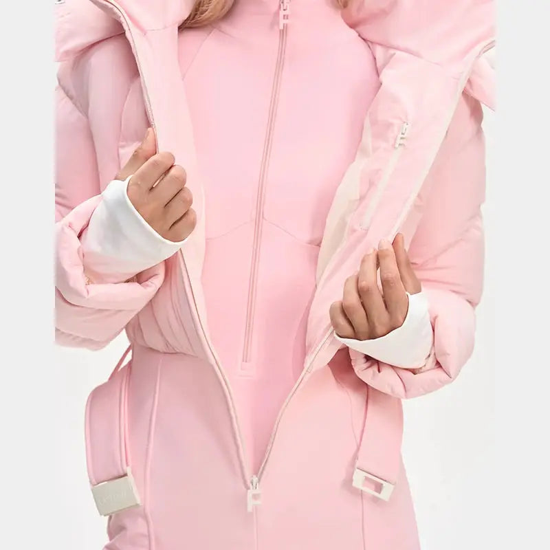 One-piece pink ski suit for women with front zipper, faux-fur hood, tassels and high-waist belt