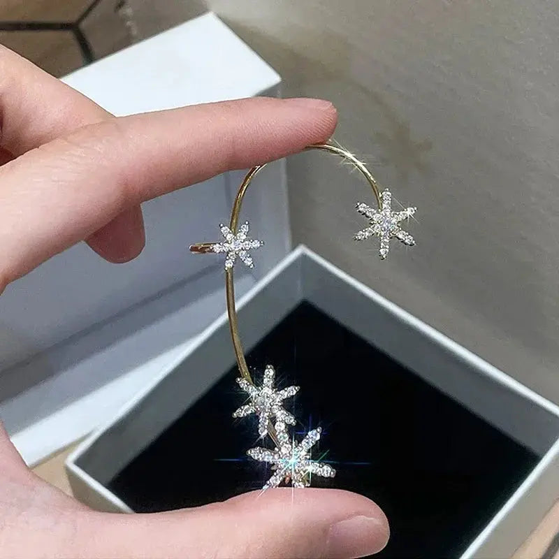 Gold-tone clip-on hoop earrings with zircon starburst accents for women