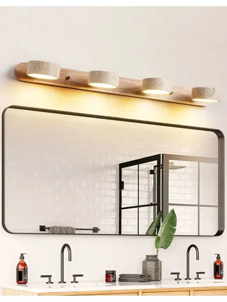 Round LED wall light bar by Simples Market on a wooden plank with four concrete-style lamps above a bathroom mirror