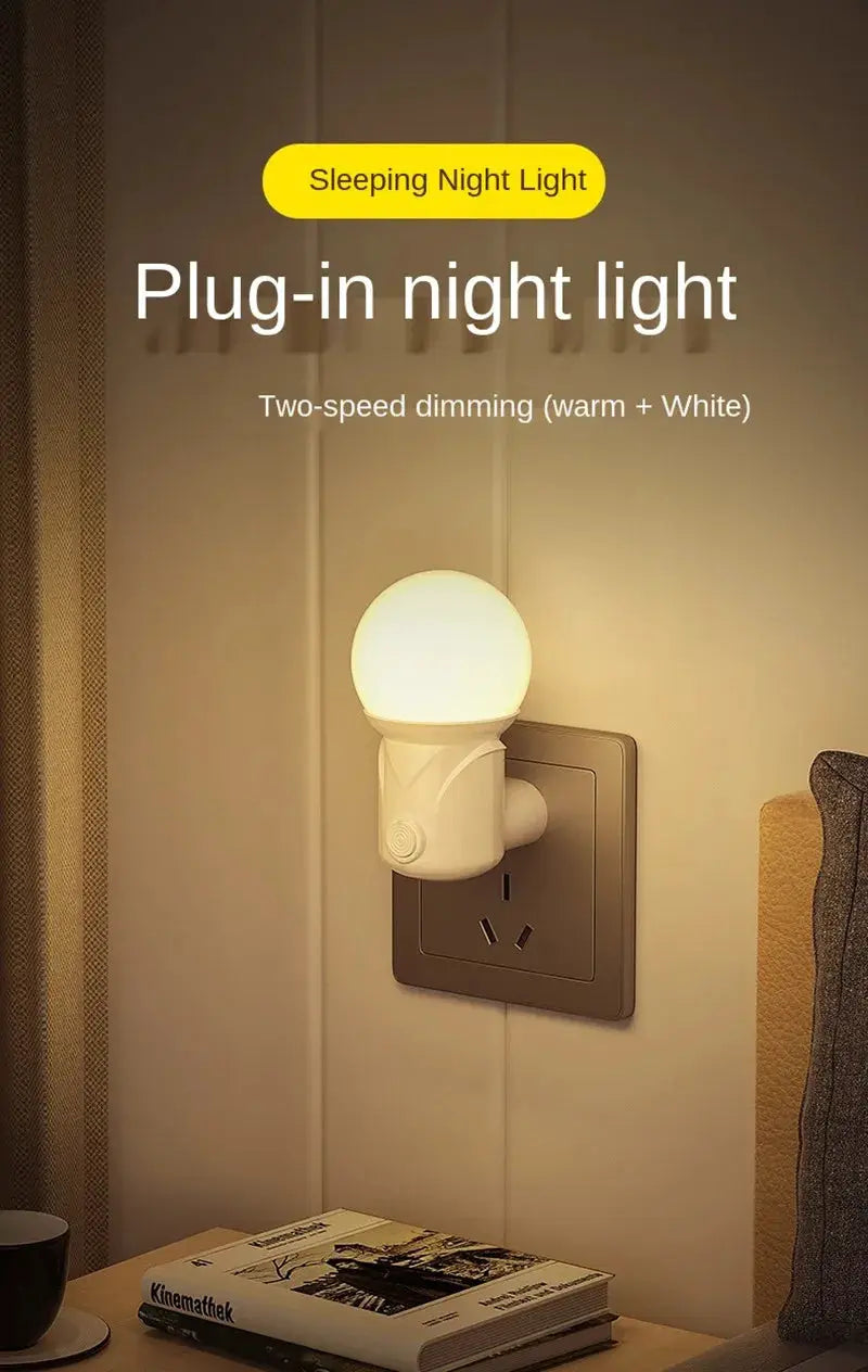 Plug-in LED night light in white plastic with a rounded globe and two-speed warm/white dimming.