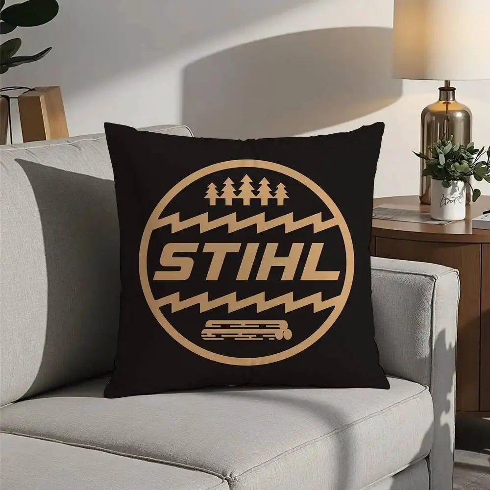 Pillow cover in black with tan STIHL logo featuring trees and a chainsaw graphic
