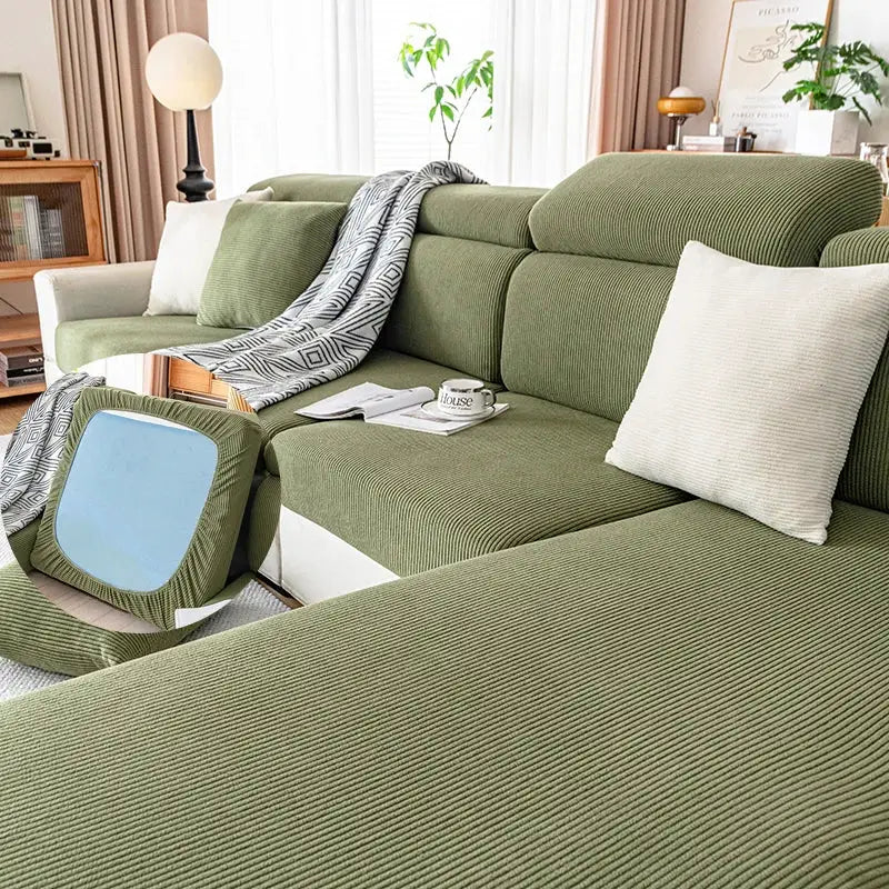 Sofa cover by Simples Market in green string-plush on a sectional sofa