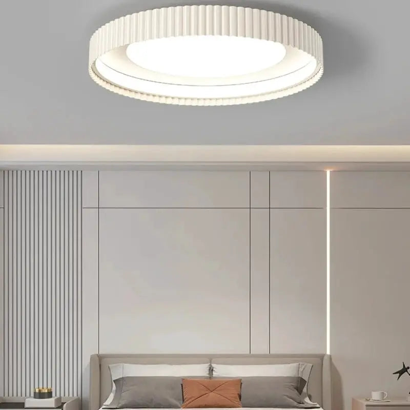 Modern round LED ceiling light fixture, white metal with ribbed edge for living/dining spaces.