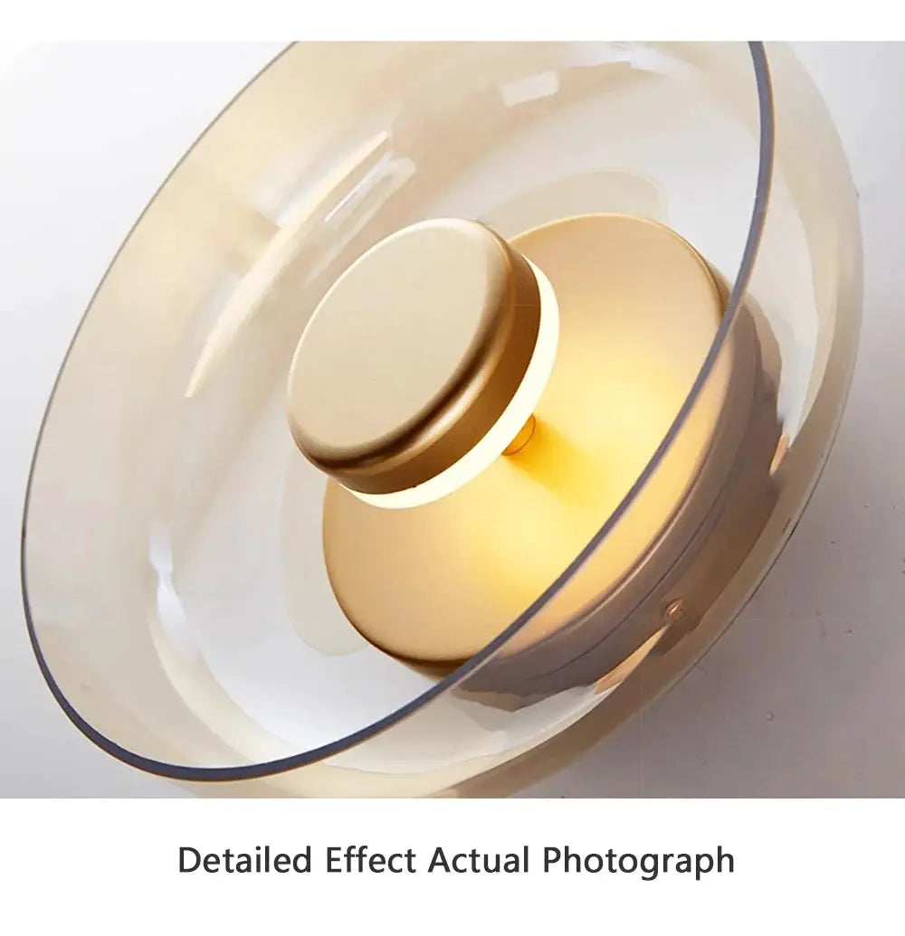 Nordic LED glass wall sconce by Simples Market with clear shade and brass finish and warm glow