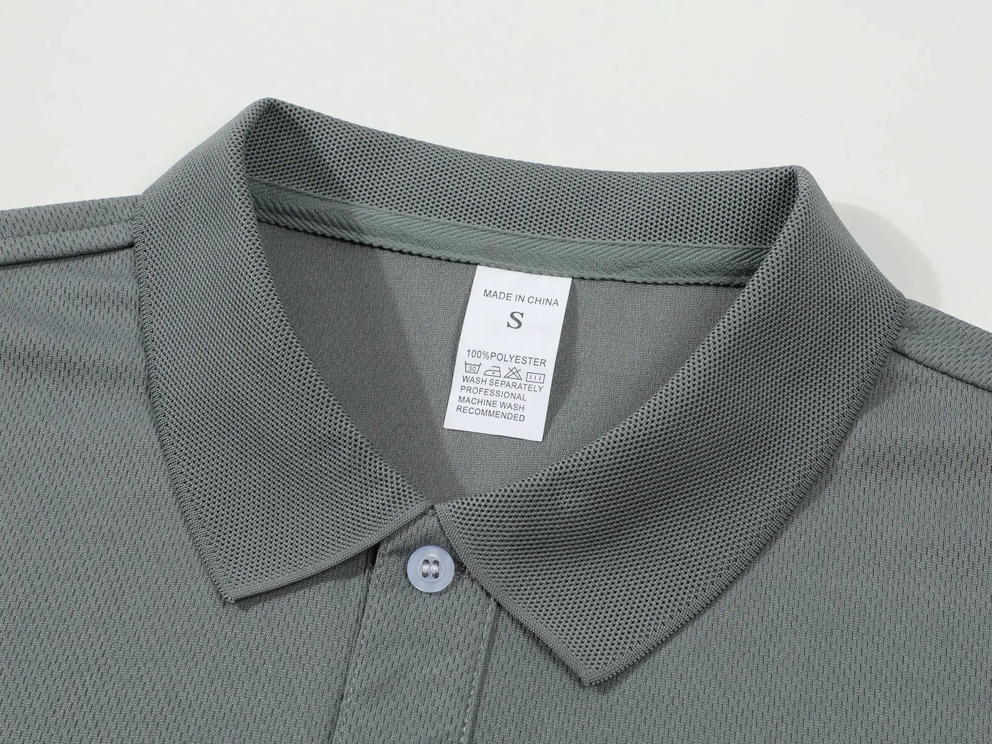 Men's gray polo shirt with textured breathable knit fabric and collar detail