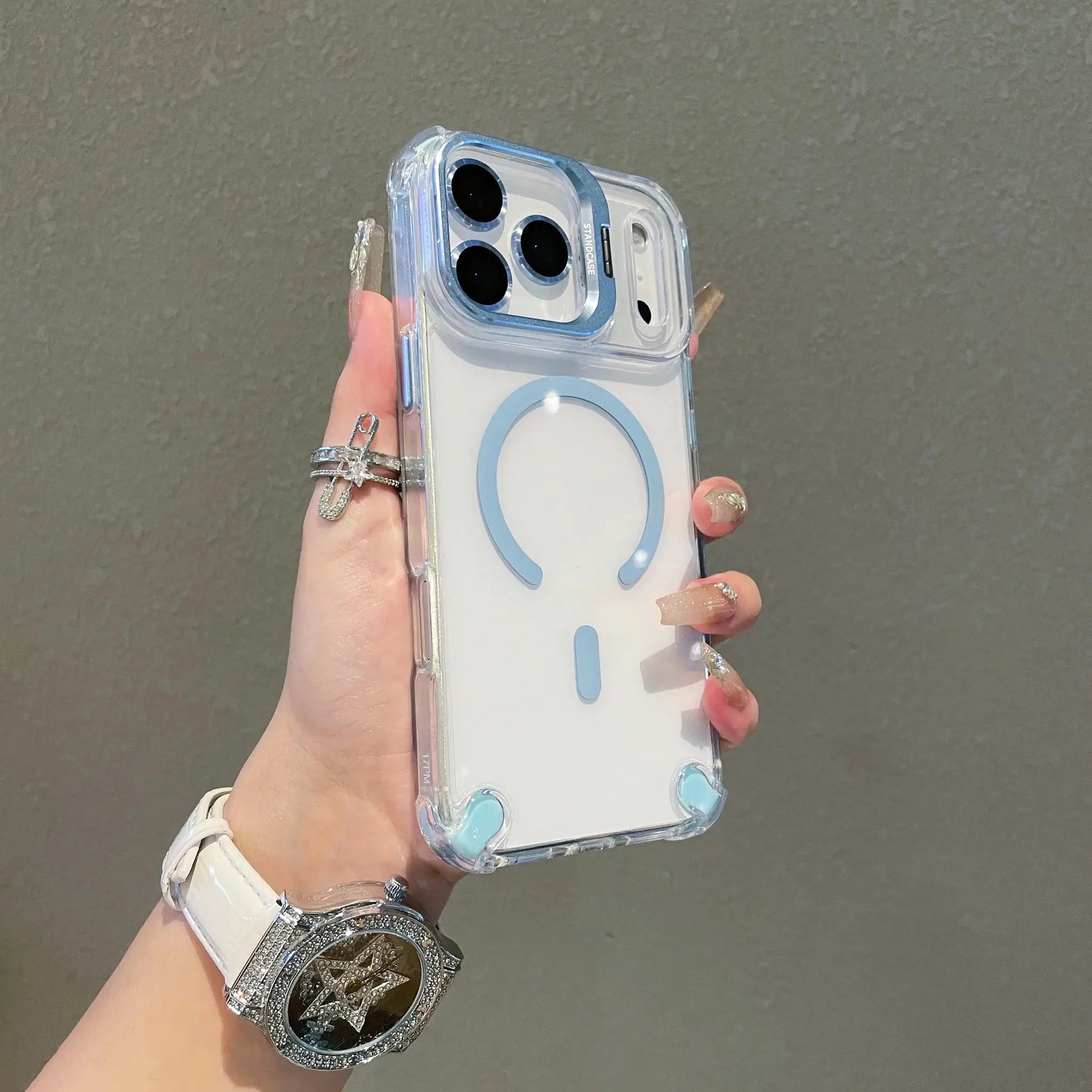 Standcase clear MagSafe iPhone case with blue camera ring and built-in stand