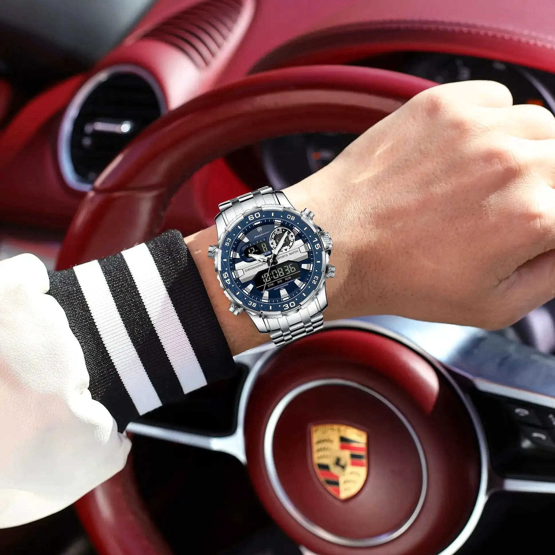 POEDAGAR electronic men's wristwatch with blue dial and silver metal band worn on the wrist in a car interior