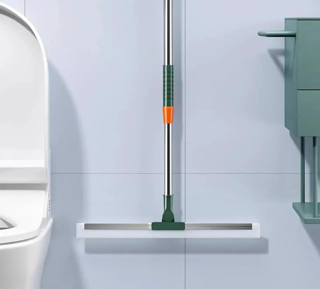 Floor squeegee with silicone scraper, green grip and orange collar on a long metal handle