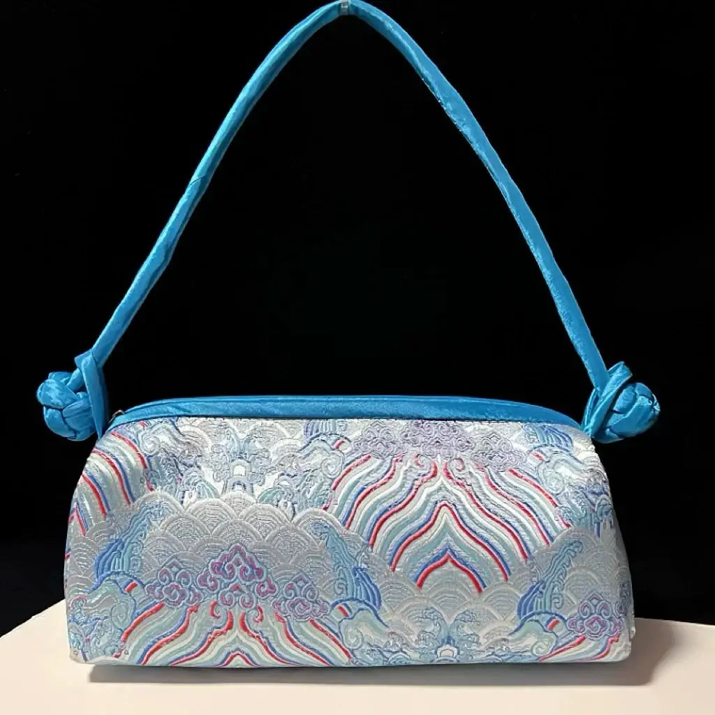 Simples Market blue satin shoulder bag with embroidered floral waves and knotted strap
