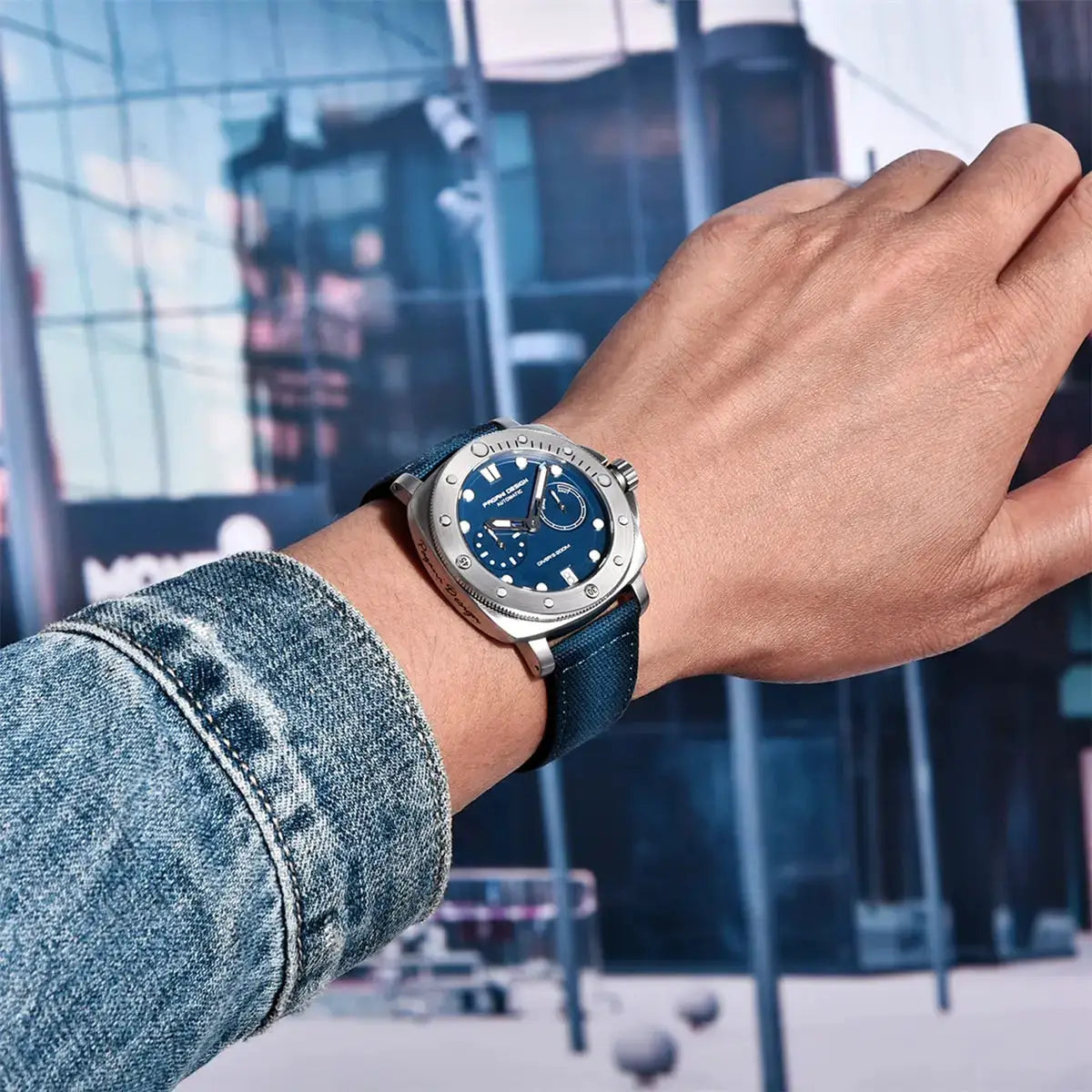 PAGANI Design men's blue dial automatic wristwatch with stainless steel case and blue fabric strap on a denim-clad wrist