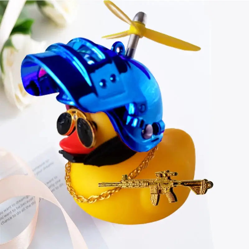 Yellow rubber duck car ornament wearing blue propeller helmet with gold chain and rifle pendant