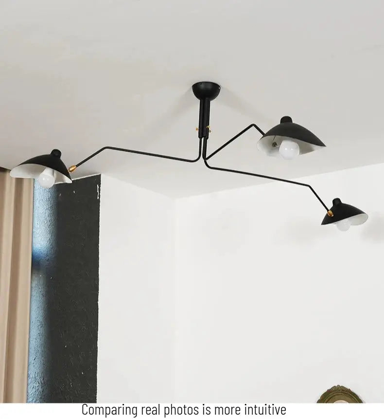 Modern spider-grabbing pendant light with black metal arms and three dome shades for living room, bedroom or study