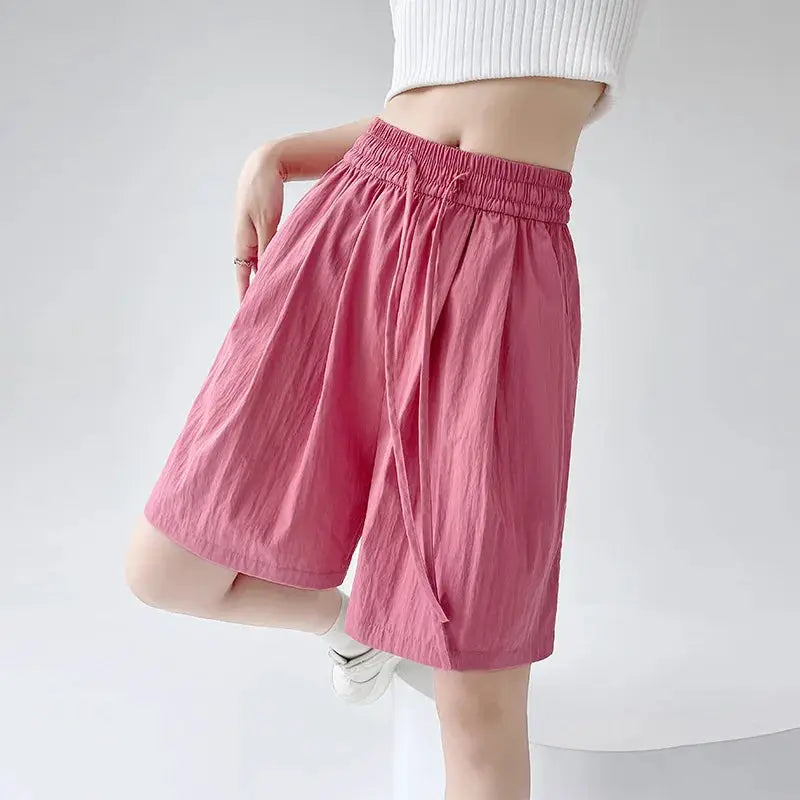 Summer women's shorts in pink with elastic high waist, two pockets, loose fit