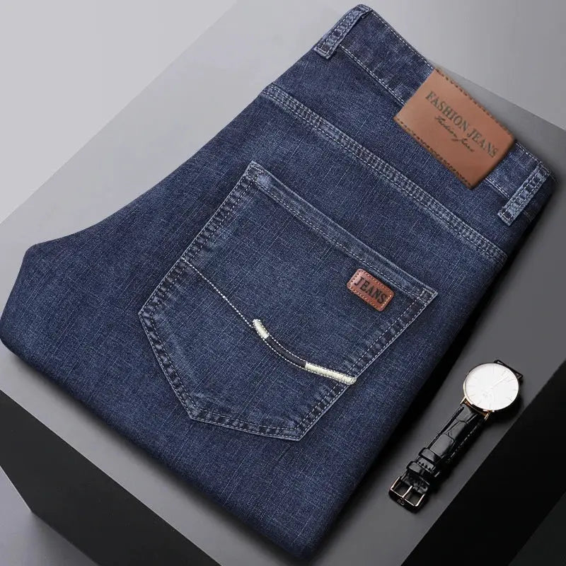 Denim jeans, dark blue folded with back pocket and brown leather label