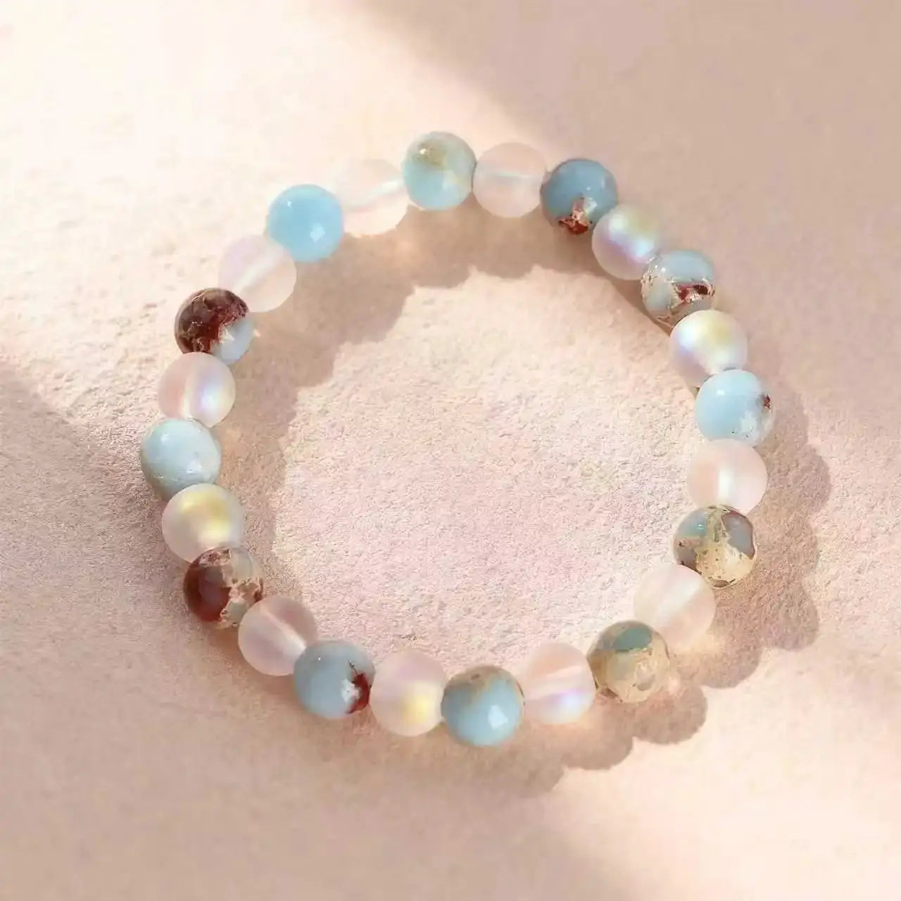 Halo Quartz Ocean Sediment beaded bracelet with pastel blue, pink, and clear beads