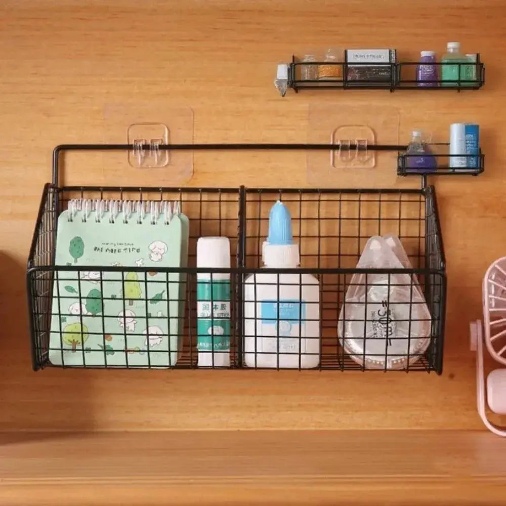 Wall-mounted black metal wire storage basket by Simples Market for spices, garlic, onions, and vegetables