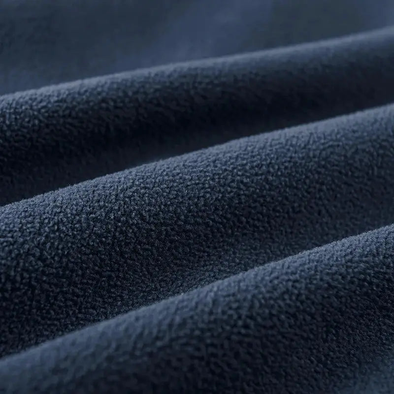 Men's navy blue fleece jacket fabric close-up showing thick textured fleece