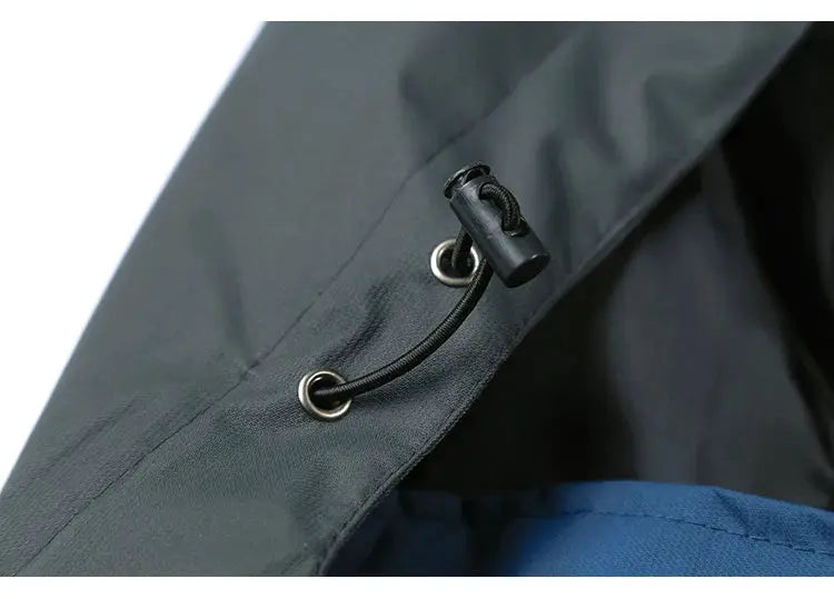 TRVLWEGO camping hiking jacket, gray exterior with blue lining, adjustable hood drawcord toggle