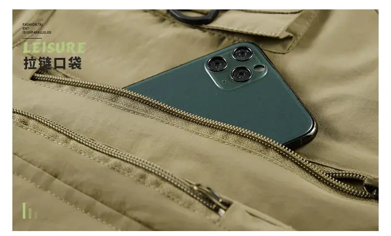 Beige men's outdoor sleeveless vest with multiple zip pockets; smartphone tucked in pocket.
