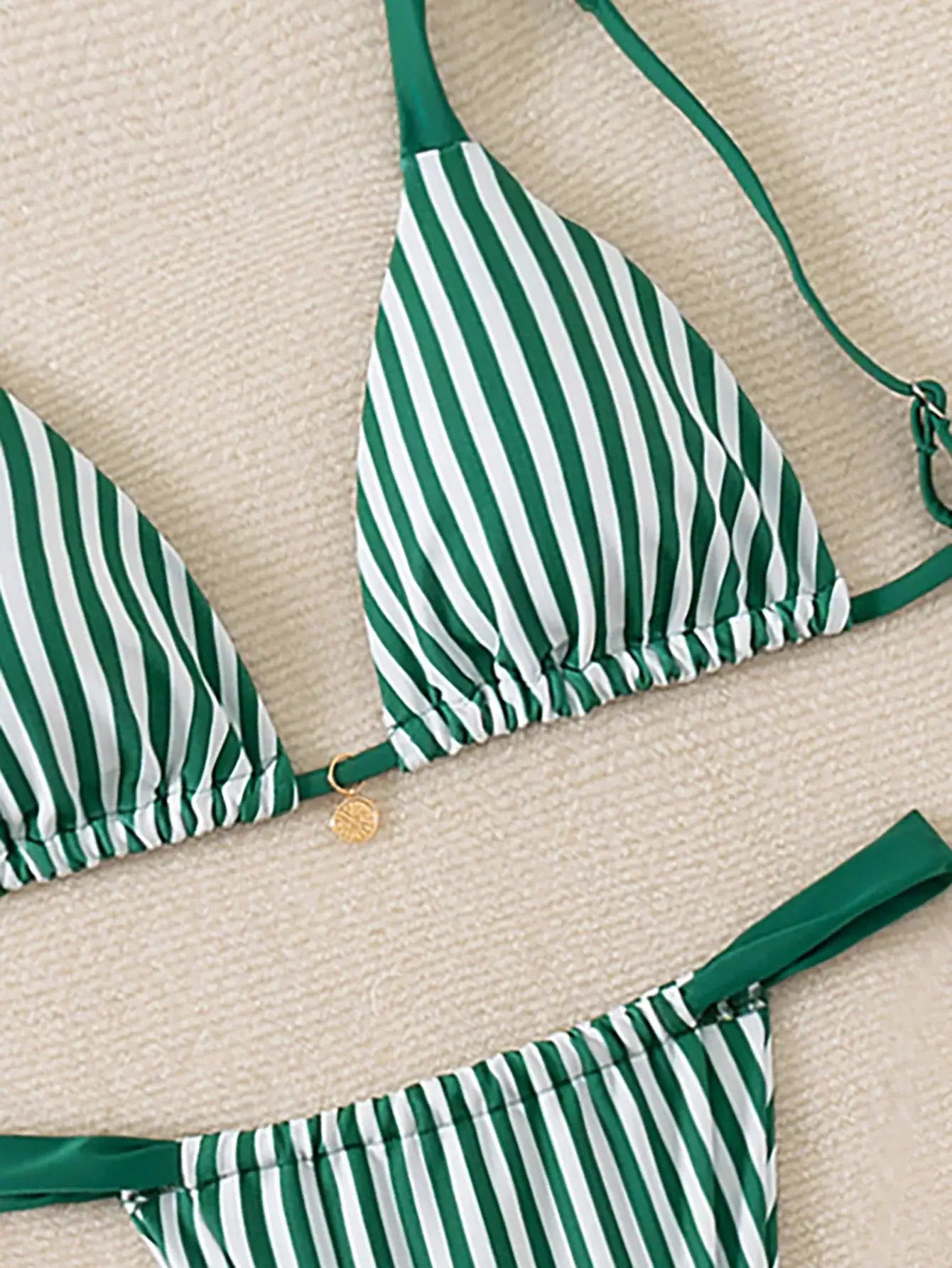 Triangle bikini set with green and white stripes, Brazilian-cut bottoms, gold charm detail