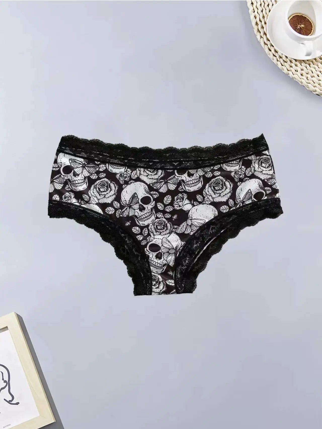 Women's lace panties with skull and rose print, black with scalloped lace trim