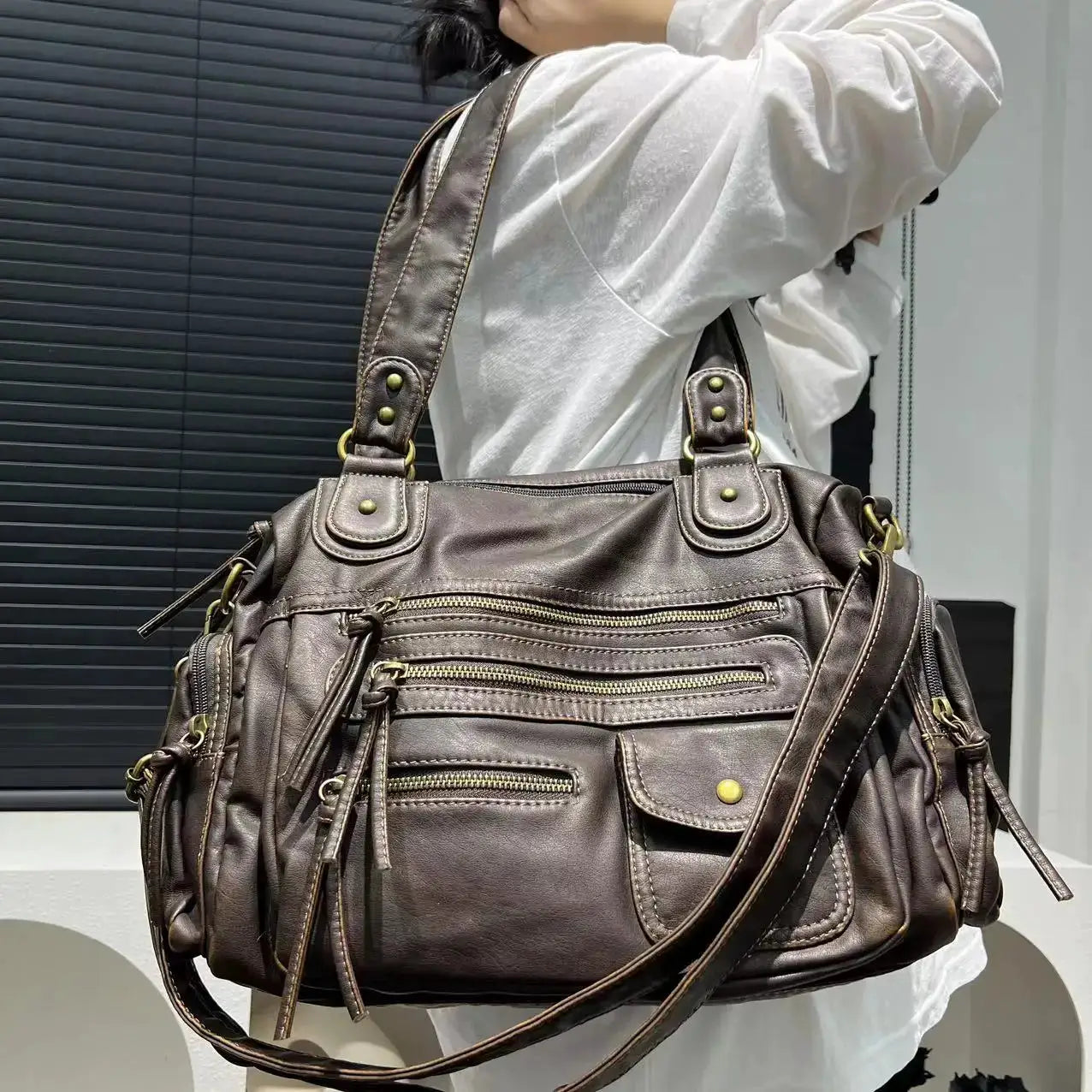 Y2K hot girl single-shoulder crossbody bag in vintage washed brown leather with multiple zip pockets.