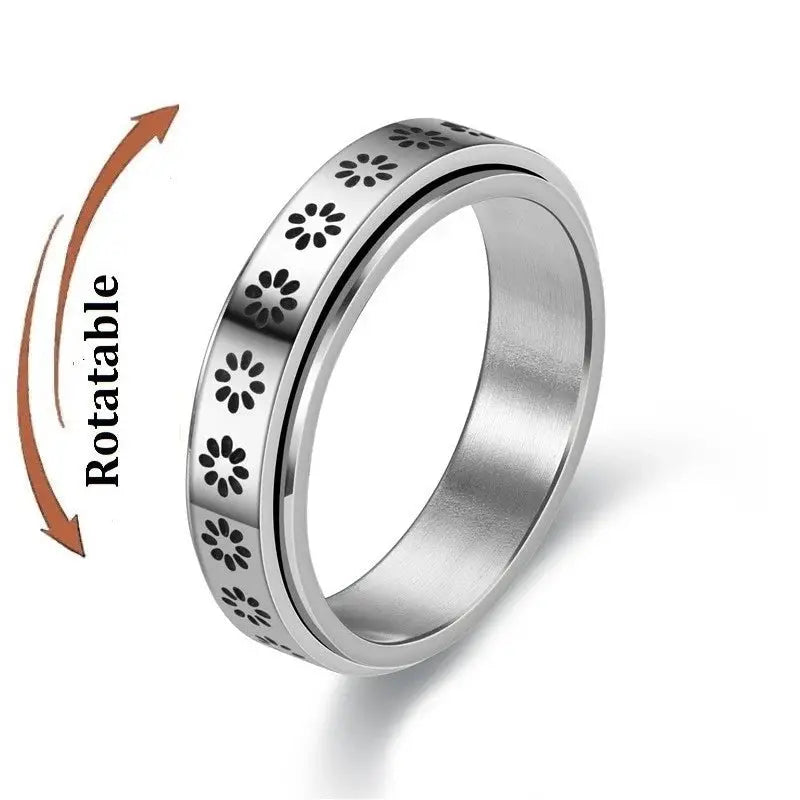 Anti-stress spinner ring in stainless steel with floral motif; unisex knuckle ring.