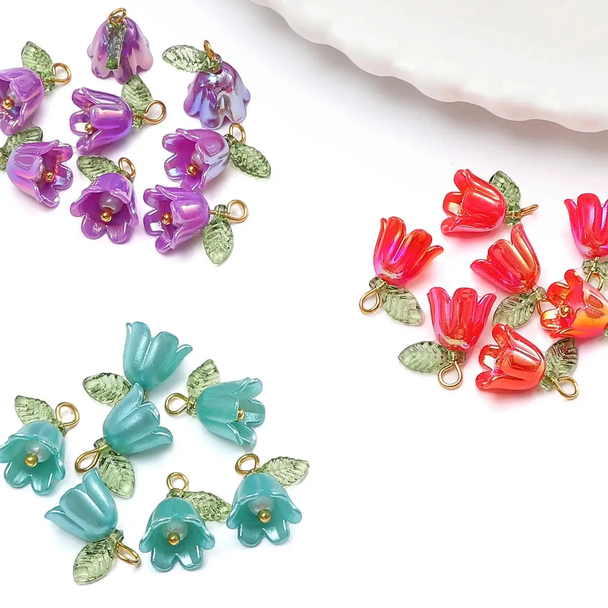 Acrylic lily-of-the-valley flower beads set (2–10 pcs) in purple, teal and red with gold loops and green leaves