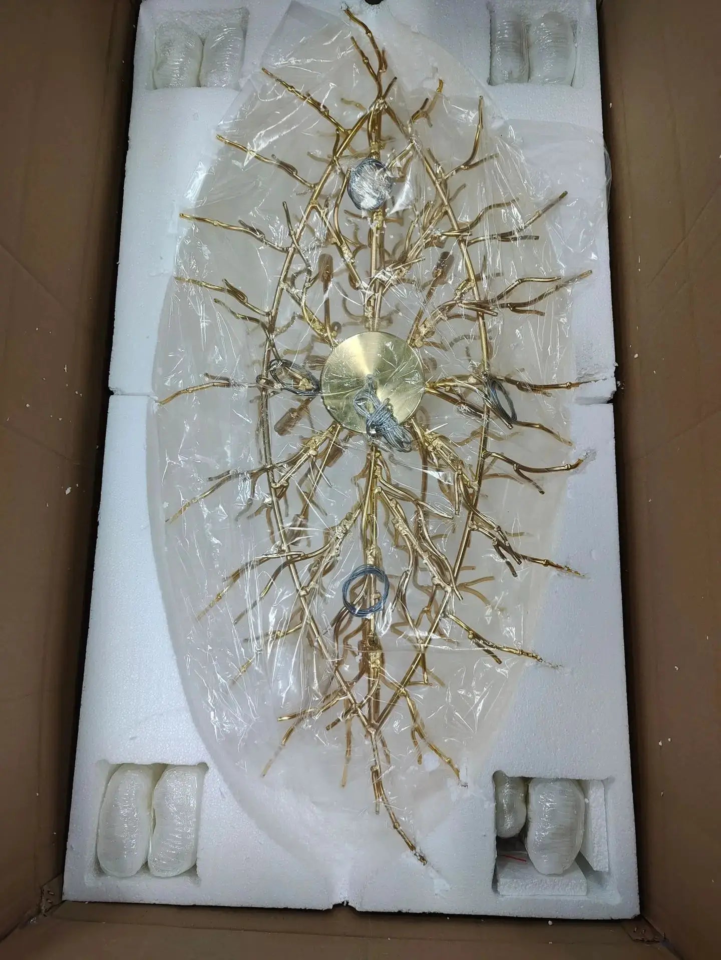 Royal Nordic luxury crystal chandelier in gold chrome with water-drop crystals by Simples Market, packed in foam.