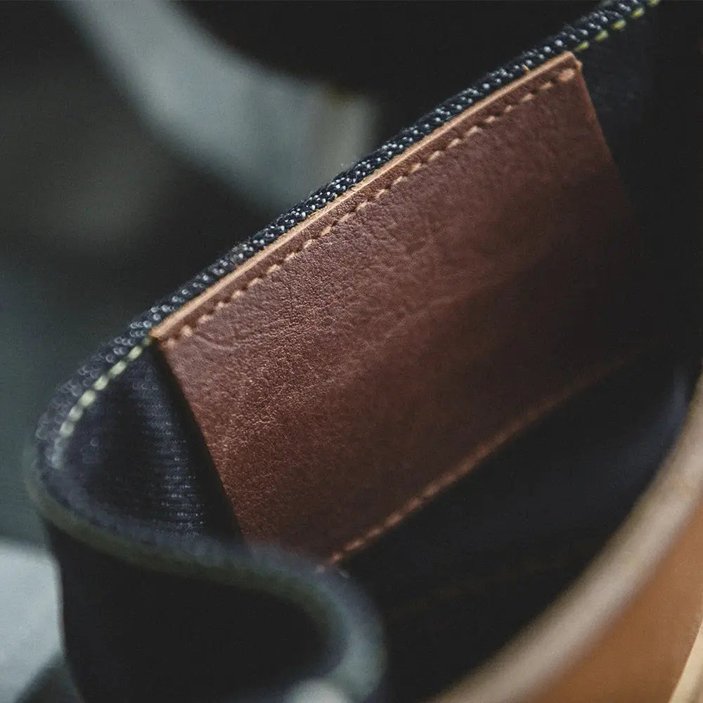 Maden Retro jeans by Simples Market; selvedge raw denim with dark brown leather patch and YKK zipper fly.