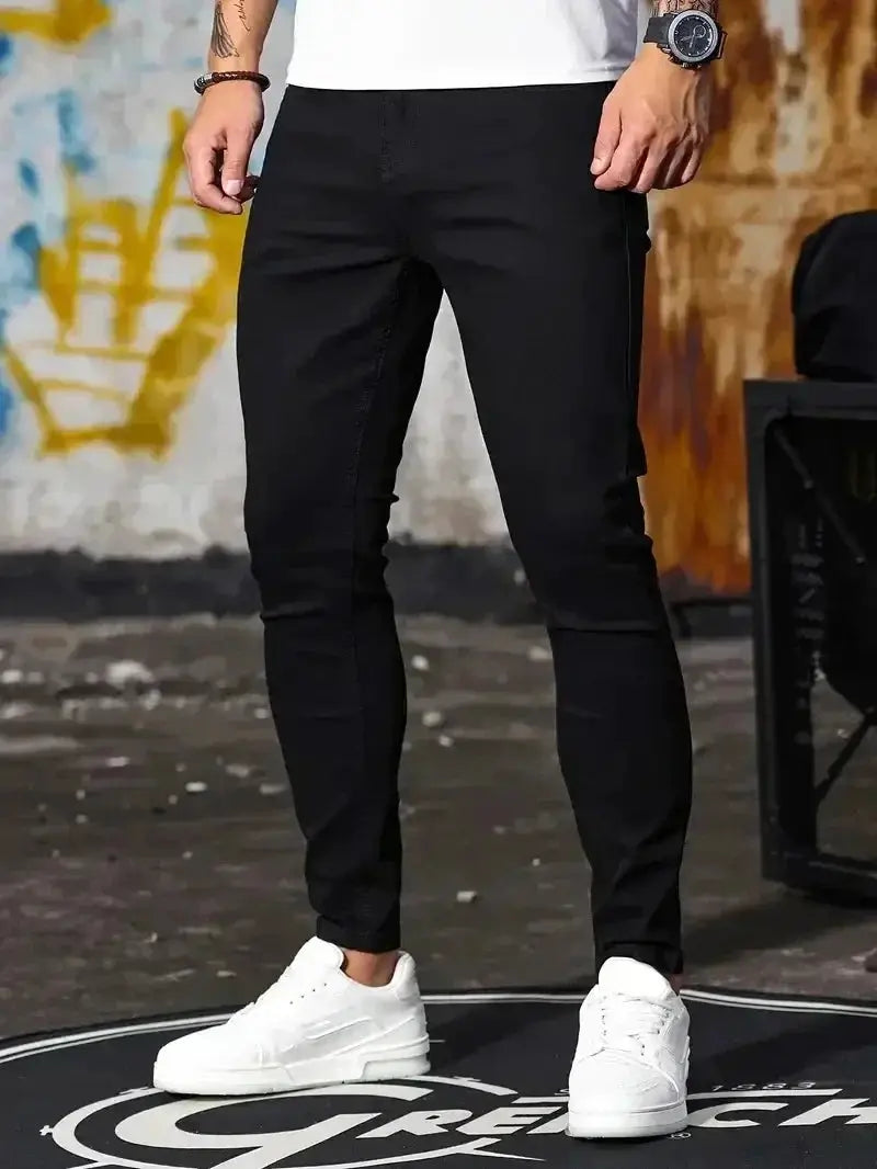 Men's slim-fit black denim jeans with a skinny silhouette for casual street style.