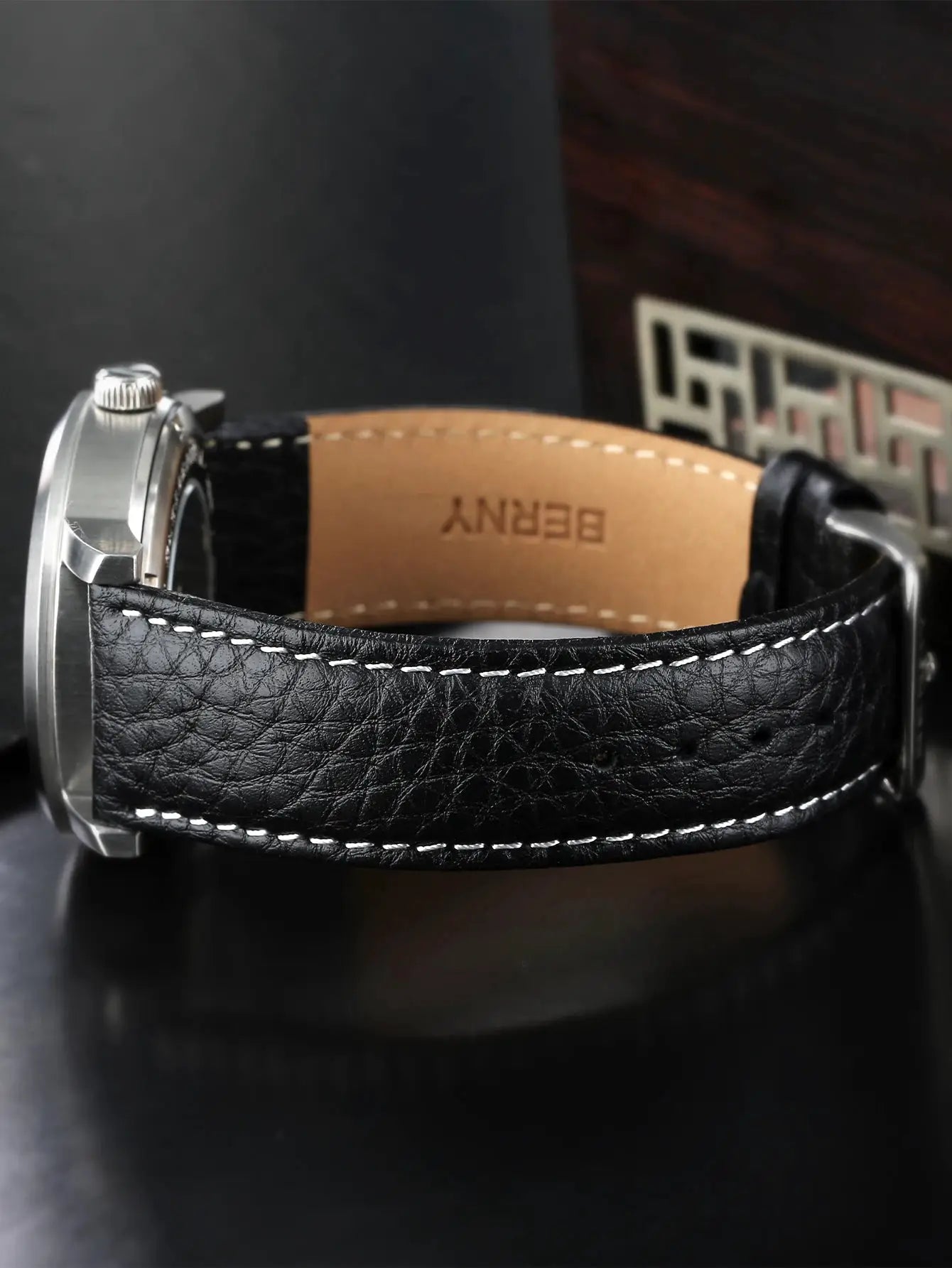 BERNY men’s wristwatch with black leather strap, white stitching and silver case