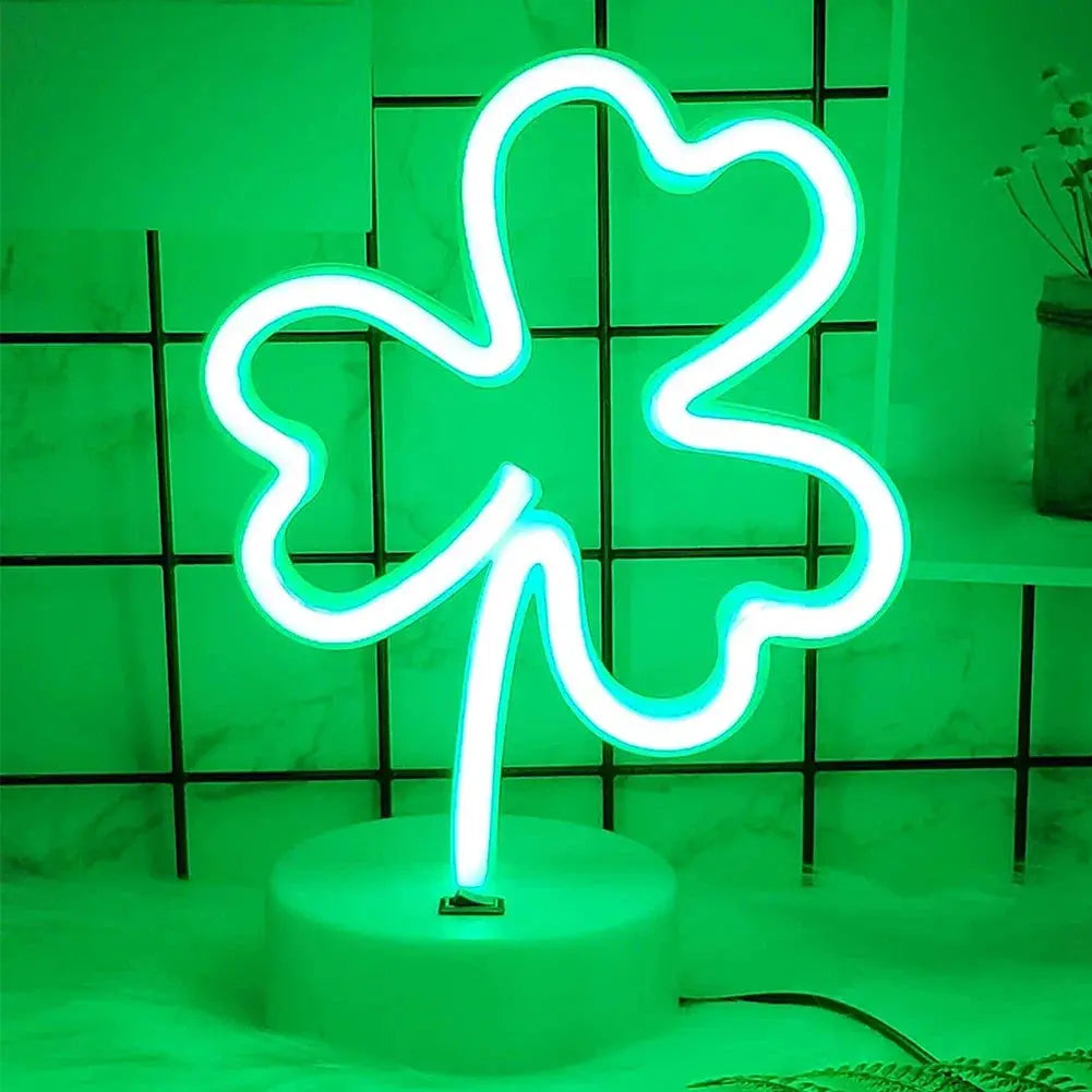 Neon LED sign in clover shape with green glow, USB powered on a round base.