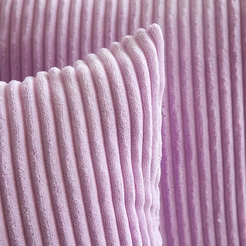 Corduroy pillow cover in soft pink with vertical ribbed plush texture for sofa decor