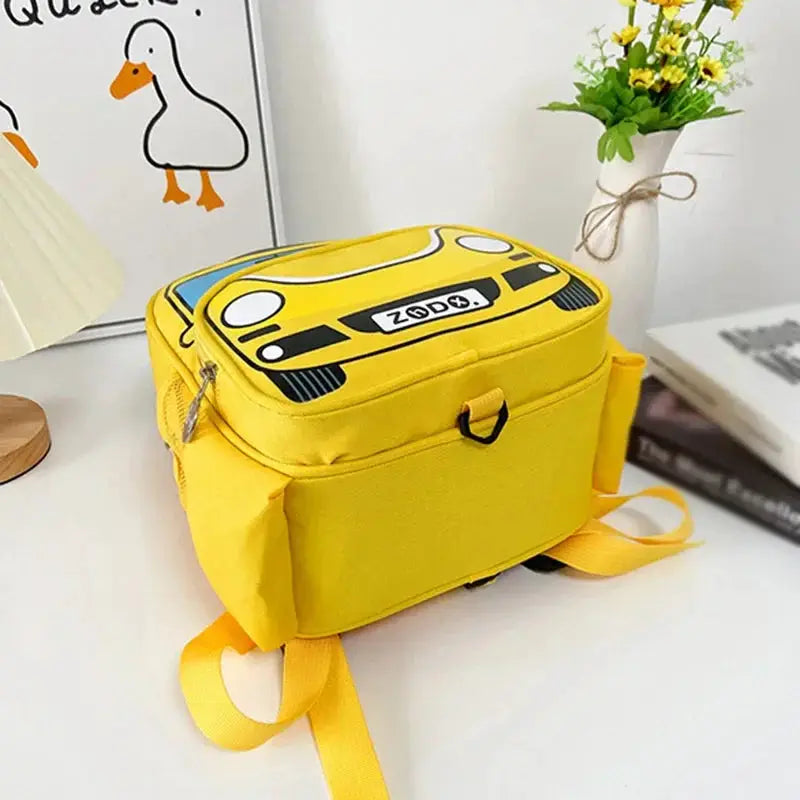 Kids' yellow police car backpack with graphic, zip pockets, and adjustable straps.